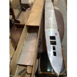 A scratch - built metal boat hull with carrying case. 70' long