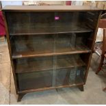 A bookcase enclosed by two pairs of sliding glass doors. 36' wide