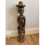 An ethnic carved treen figure. 33' high