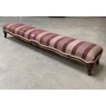 An upholstered long footstool on moulded cabriole legs. 46' long