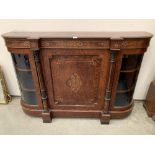 A Victorian inlaid amboyna side cabinet with central panelled door flanked by gilt fluted pilasters.