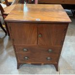 A Regency mahogany pot cupboard enclosed by a pair of doors over a deep drawer. 23' wide