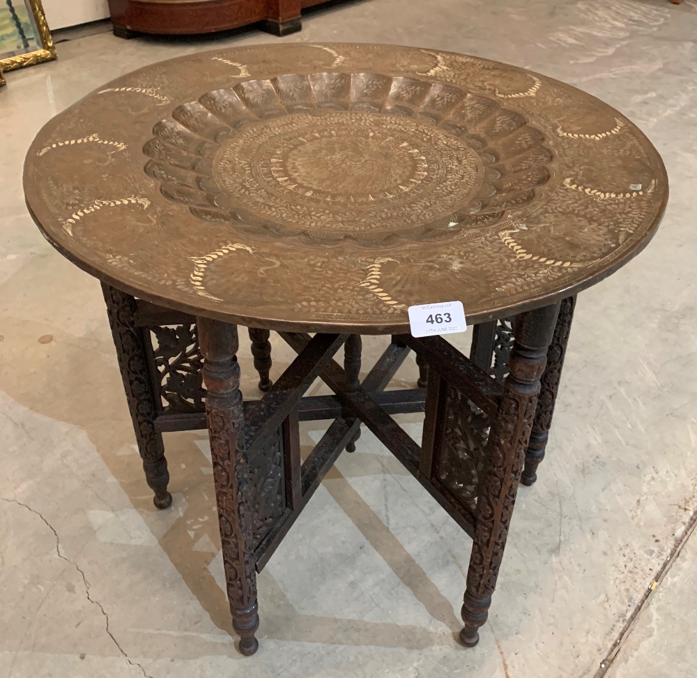 A Benares tray top table on fret and blind carved folding base. 23' diam