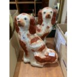 A pair of iron red glazed Staffordshire spaniels