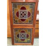 Two Victorian stained glass panels in a pine frame. 50' x 26½'. Cracks, losses