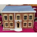 A dolls house in the form of a five bay Georgian house. 36' wide x 27' high