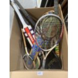 A collection of vintage raquets, two vintage cricket bats and hockey sticks