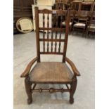 A 19th century Lancashire spindle back elbow chair with rush seat