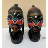 Two carved wood and bead applied African heads, 9' high