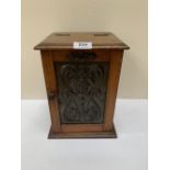 An Arts and Crafts style oak smoker's cabinet to include five tobacco pipes. 11' high