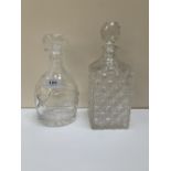Two cut glass decanters. Both with chipped rims.