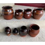 Four Buckley slip banded jars; a Buckley jar and three items of black glazed earthenware (8)