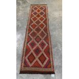 A Suzni Kilim carpet runner. 2.79m x 0.76m