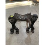 A pair of cast iron fire dogs with grate