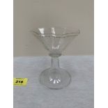 An octagonal wine glass with jewelled rim on downswept foot. 4¾' high