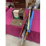 A fishing basket and various rods etc.