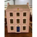 A dolls house in the form of a three bay Georgian dwelling. 34' high