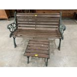 A cast iron and wood slatted garden bench and table