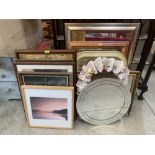 A collection of wall mirrors and framed prints