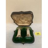 An Edward VII pair of silver peppers in morocco case. Sheffield 1909. Case A.F.