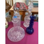 Three decanters (one lacking stopper) and a blue glass vase with trailed decoration. (4)