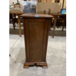 An early 20th century mahogany and inlaid pot cupboard on bracket feet