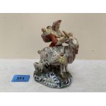 A 19th century Staffordshire group, lady astride a ram with two infants in a basket on her back. 5¼'