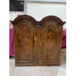 A walnut cabinet in early 18th century style, the pair of arch panel doors enclosing three