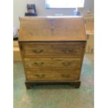 An Edward VII mahogany and inlaid writing bureau, the marquetry fall over three long drawers on