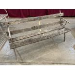 A cast iron and wood slatted garden seat with branch moulded ends. 60' long