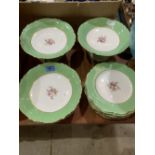 A 12 piece dessert service painted with sprays of summer flowers