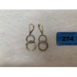 A pair of gem set earrings of double interlocking hoop design. In gold marked 375. 4g gross