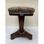 An early Victorian rosewood piano stool with height adjustable seat on tripartite platform support