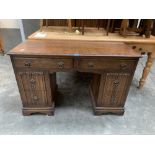 An oak linenfold moulded kneehole desk. 46' wide