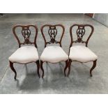 A set of three Victorian rosewood salon chairs with interlaced splats on French cabriole legs