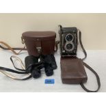 A cased pair of Carl Zeiss. Deltrintem 8 x 30 binoculars and a Rolleiflex Synchro-Compur twin lens