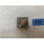 A modernist design diamond ring. In gold marked 750. 10g gross. Size T