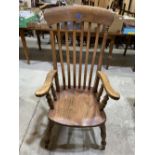 A 19th century lath-back elbow chair with elm seat on splayed legs