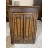 A 19th century oak and mahogany hanging corner cupboard. 48' high