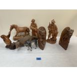 A collection of carved wood animals and figures