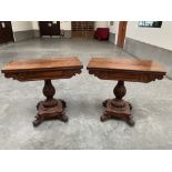 A pair of William IV mahogany card tables, the fold-over tops raised on reeded baluster columns