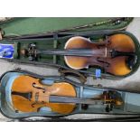 Two cased violins