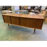 A 1970s teak sideboard enclosed by four sliding doors. 79' long