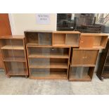 Seven bookcases enclosed by glazed or blind sliding doors