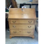 A pine writing bureau with three drawers. 36' wide