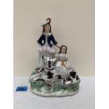A 19th century Staffordshire group of mother, child and hound. 10' high
