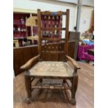 A 19th century oak Lancashire spindle back elbow chair with rush seat