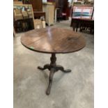 A 19th century oak snap-top tripod table on cabriole support. 32' diam