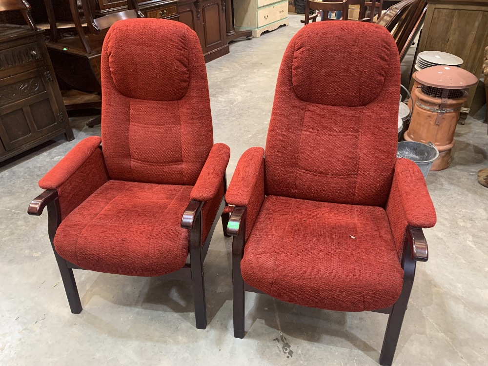 A pair of reclining upholstered armchairs