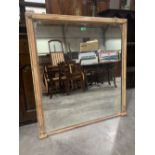 A 19th century Regency style overmantle mirror, the moulded parcel gilt frame with applied